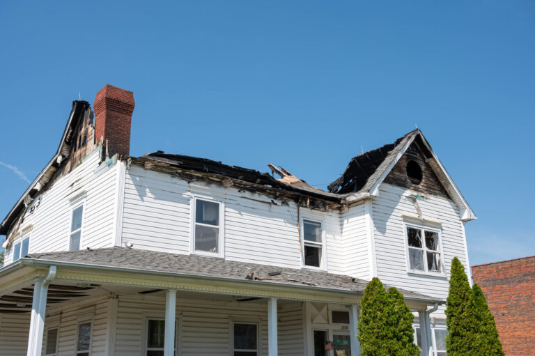 Fire-damaged residential home with severe roof and structural damage prior to restoration by Paul Davis Restoration of Tri-County, MD