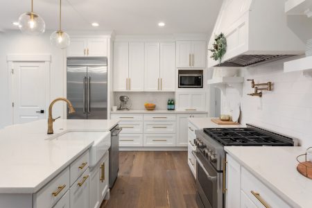 beautiful kitchen in new luxury home with island, pendant lights elegant kitchen, furnished and staged